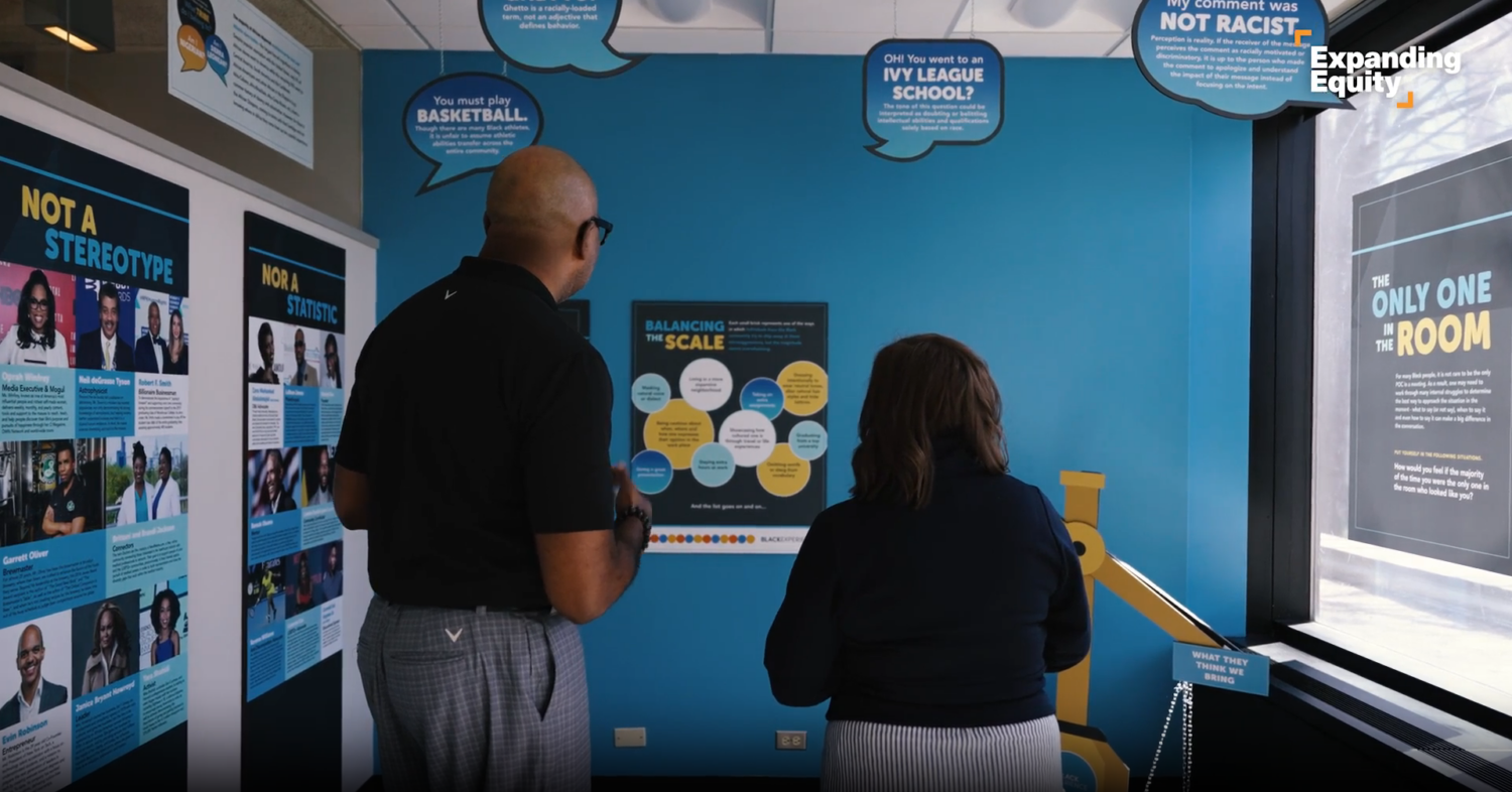 Two people standing together looking at an exhibit
